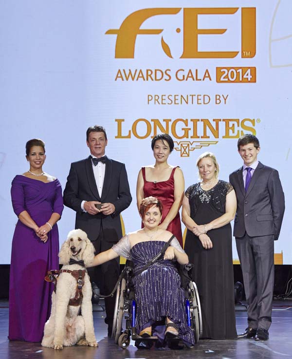 HRH Princess Haya, Jeroen Dubbeldam (NED), Melissa Tan (SIN) chairman of equine therapy centre Equal Ark, Jackie Potts (GBR), Lambert Leclezio (MRI) with (centre) Sydney Collier (USA) and her service dog Journey. (FEI/Liz Gregg)
